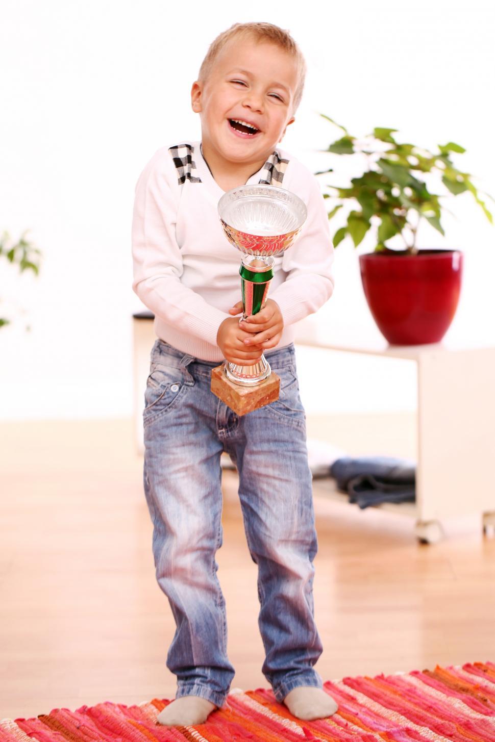 Free Image of Kid is excited to win a trophy 