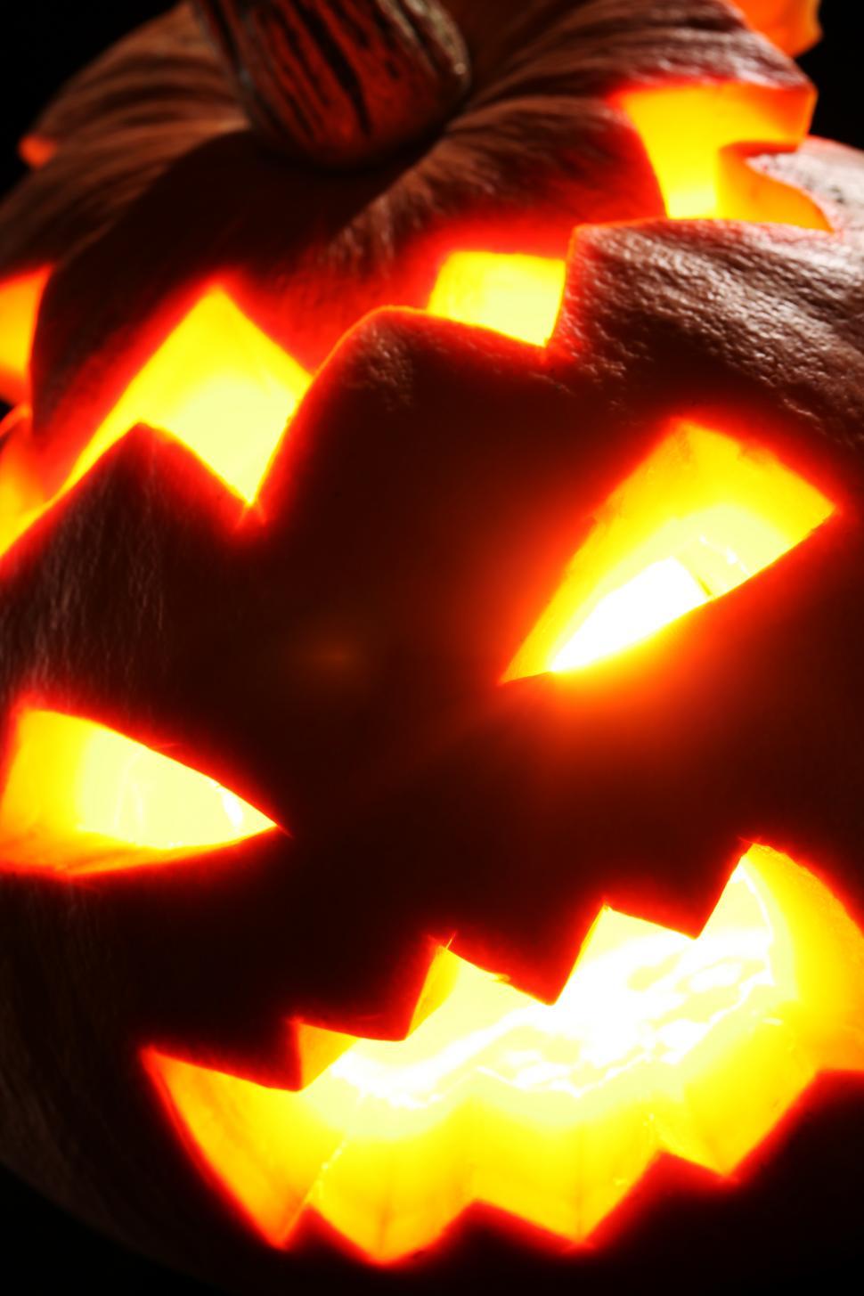 Free Image of Close up of scary glowing jack o lantern face 