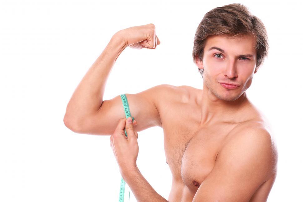 Free Image of Guy being goofy, measuring his muscles 