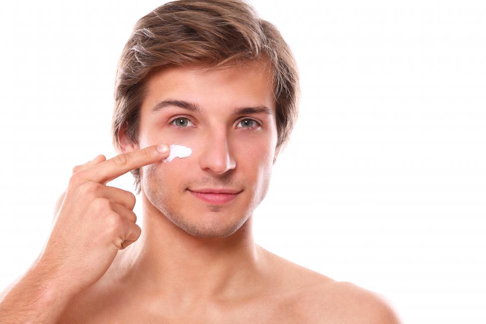 Free Image of Man applying face cream 