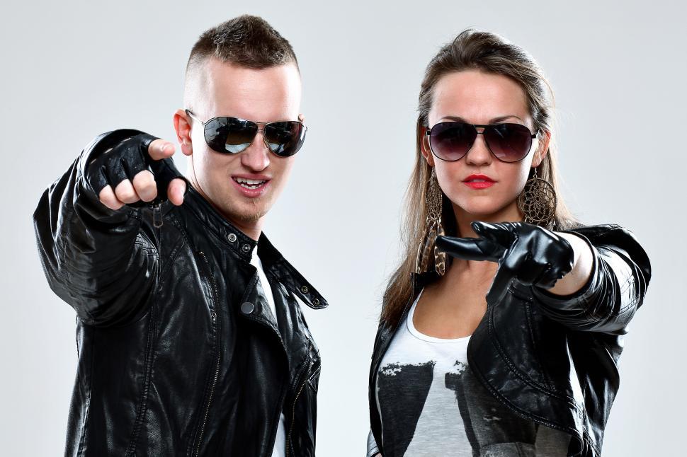 Free Image of Leather wearing people pointing at the camera 