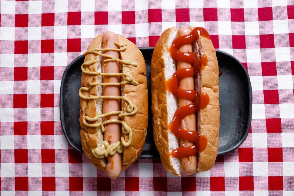 Free Image of Hot dogs on red and white checkered tablecloth 