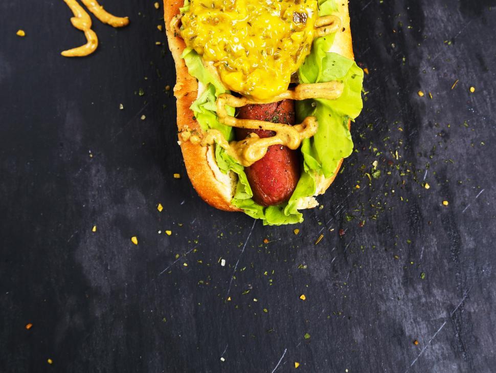 Free Image of One end of a hot dog, lots of mustard 