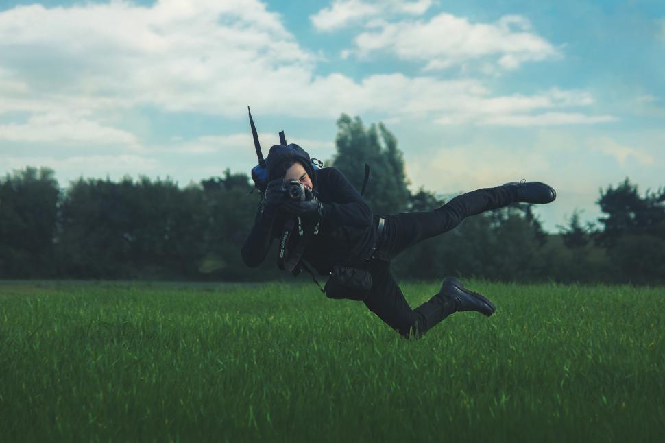 Free Image of Male photographer doing stunts in the greenfield 