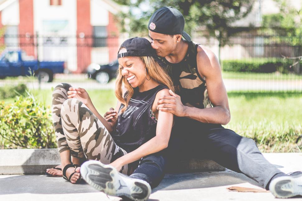 Free Image of Young stylish man and woman embracing each other on the pavement 