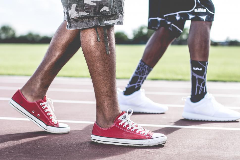 Free Image of Two men walking in sneakers 