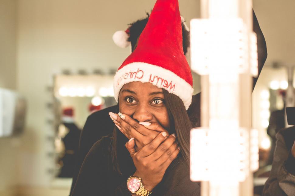 Free Image of Surprised Woman in Christmas hat - face on mouth 