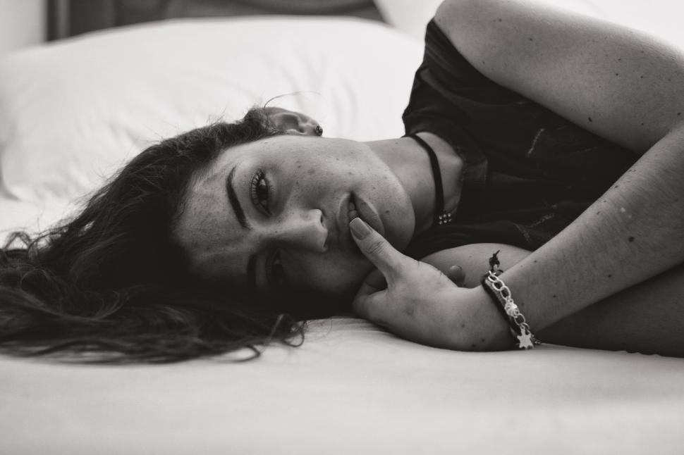 Free Image of Woman lying on bed 