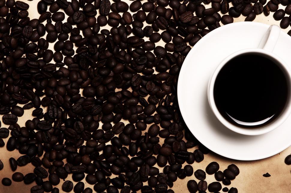 Free Image of Coffee background - while beans and coffee cup 