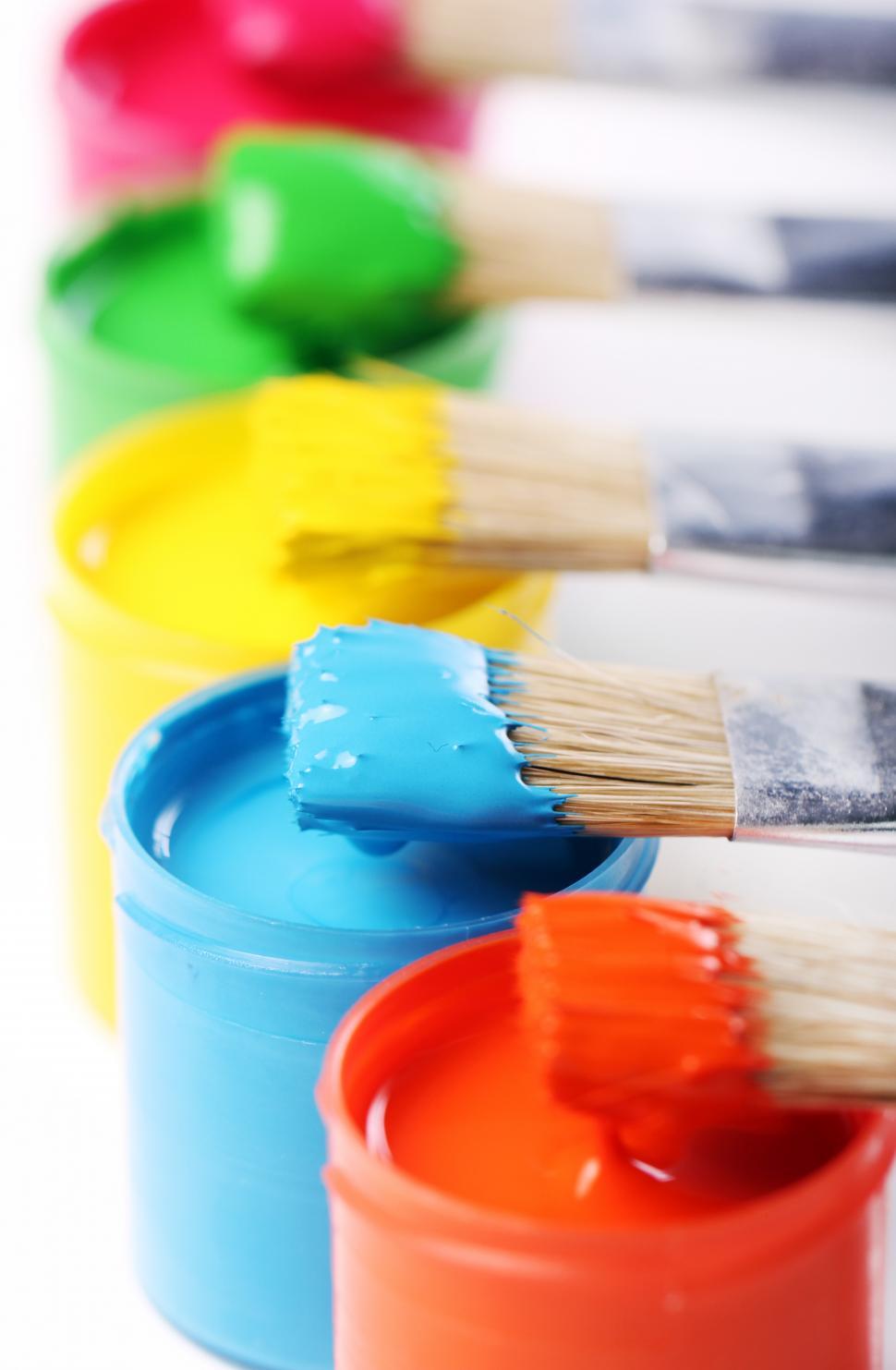 Free Image of Paint brushes dipped in colorful paint 