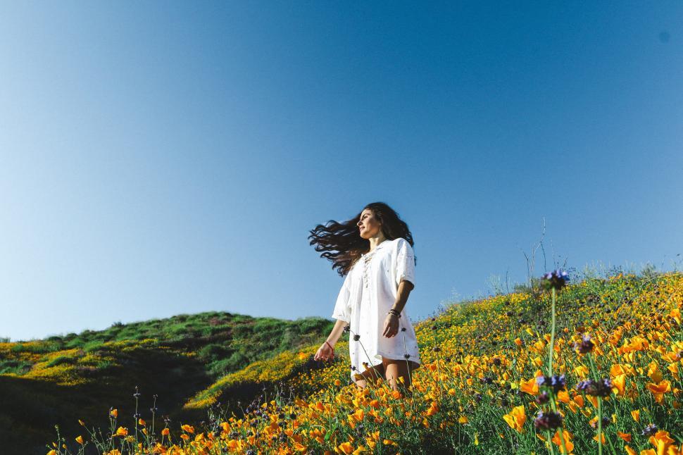 Free Image of Woman in flower field - looking away 