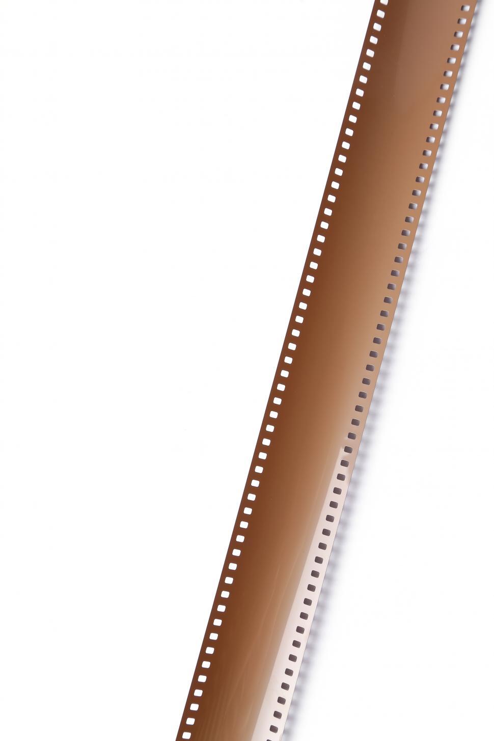 Free Image of 35 mm film unrolled on white background 