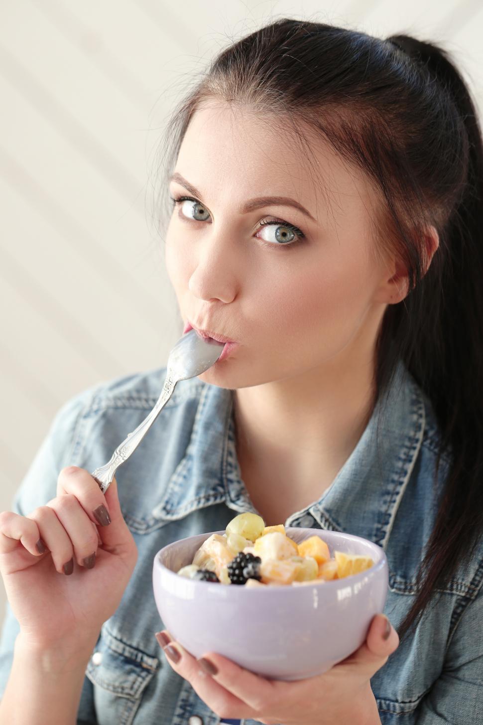 Free Image of Woman eating light breakfast 