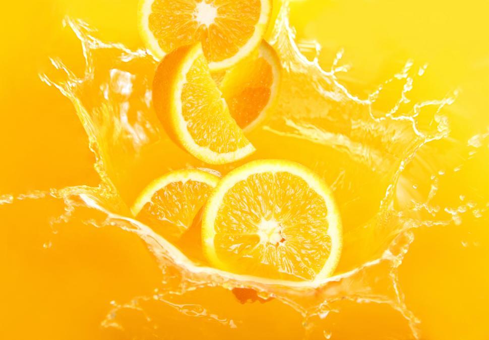 Free Image of Fresh orange slices falling into juice 