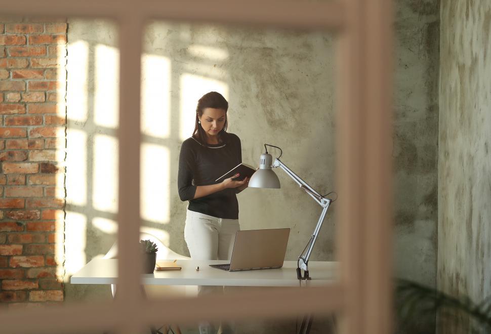 Free Image of Professional woman standing at desk 