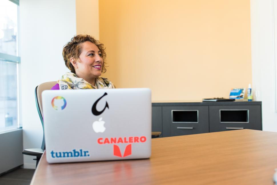 Free Image of Happy Businesswoman with laptop on table in meeting room 