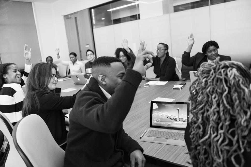 Free Image of Happy business people raising hands up during a meeting in offic 