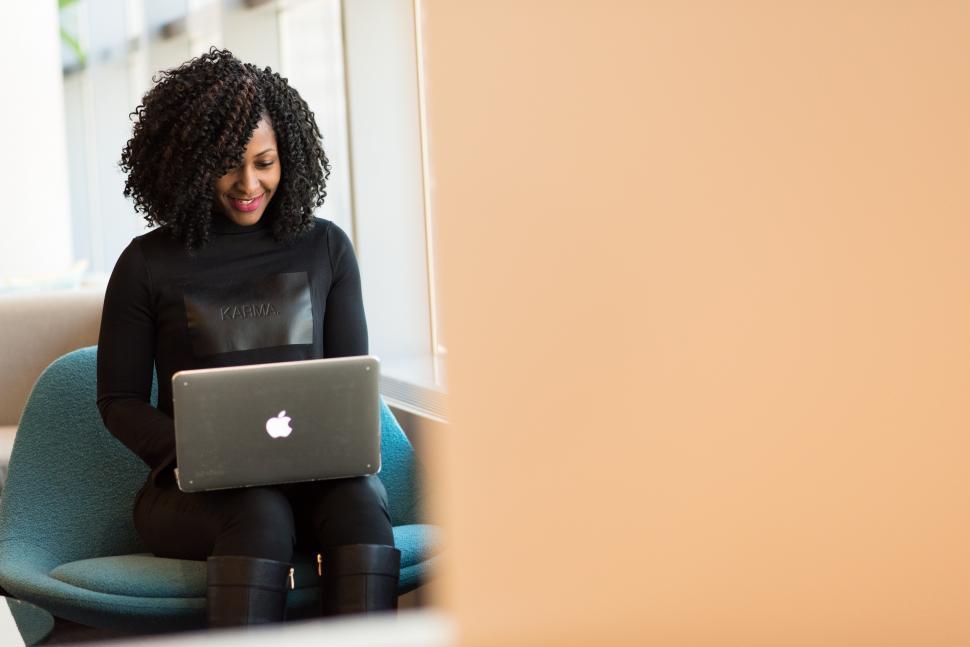 Free Image of Smiling businesswoman in casual clothing with laptop 