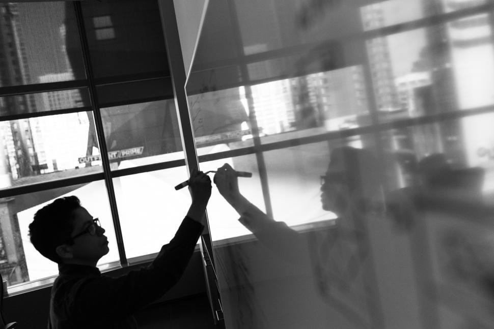 Free Image of Businessman hand with marker pen and whiteboard - b&w 