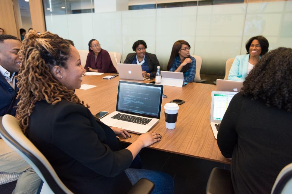 Free Image of Business people smiling and working together in meeting room 