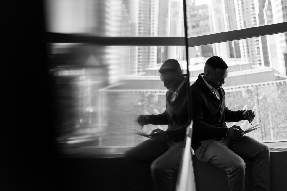 Free Image of Businessman with laptop near glass window - b&w 