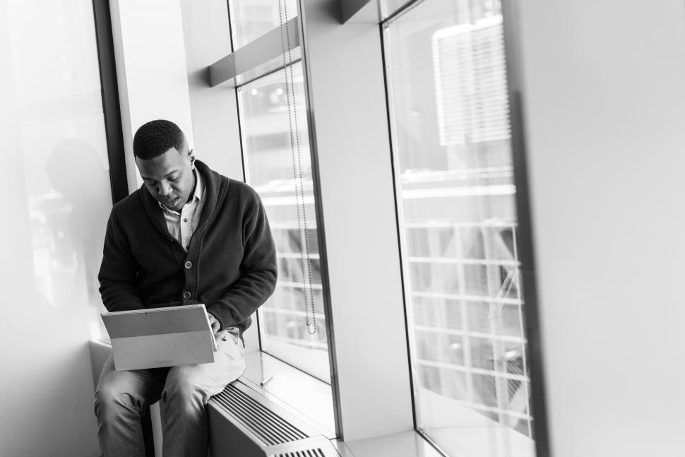 Free Image of Businessman with tablet near glass window - b&w 