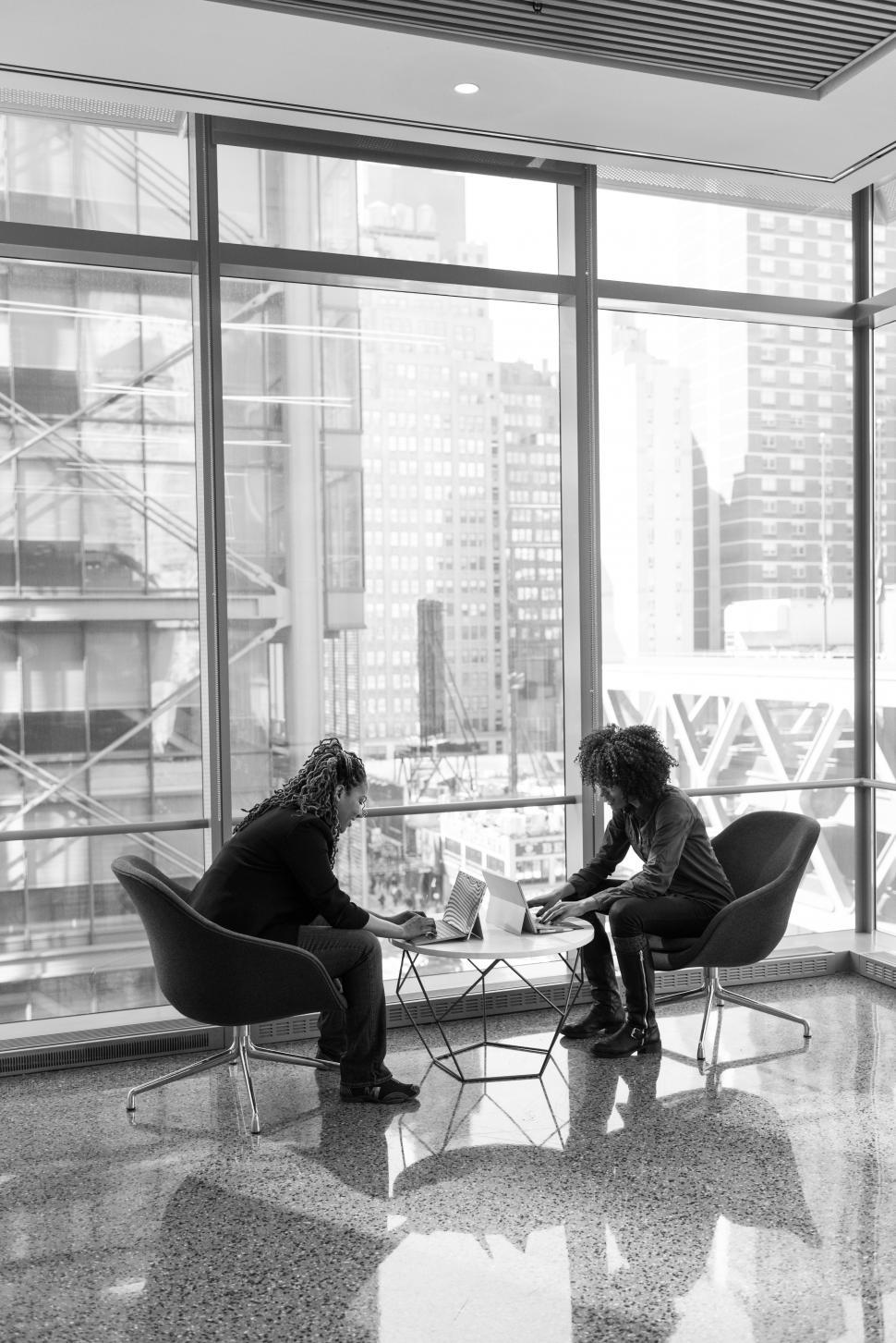 Free Image of Female co-workers using tablet device - b&w 