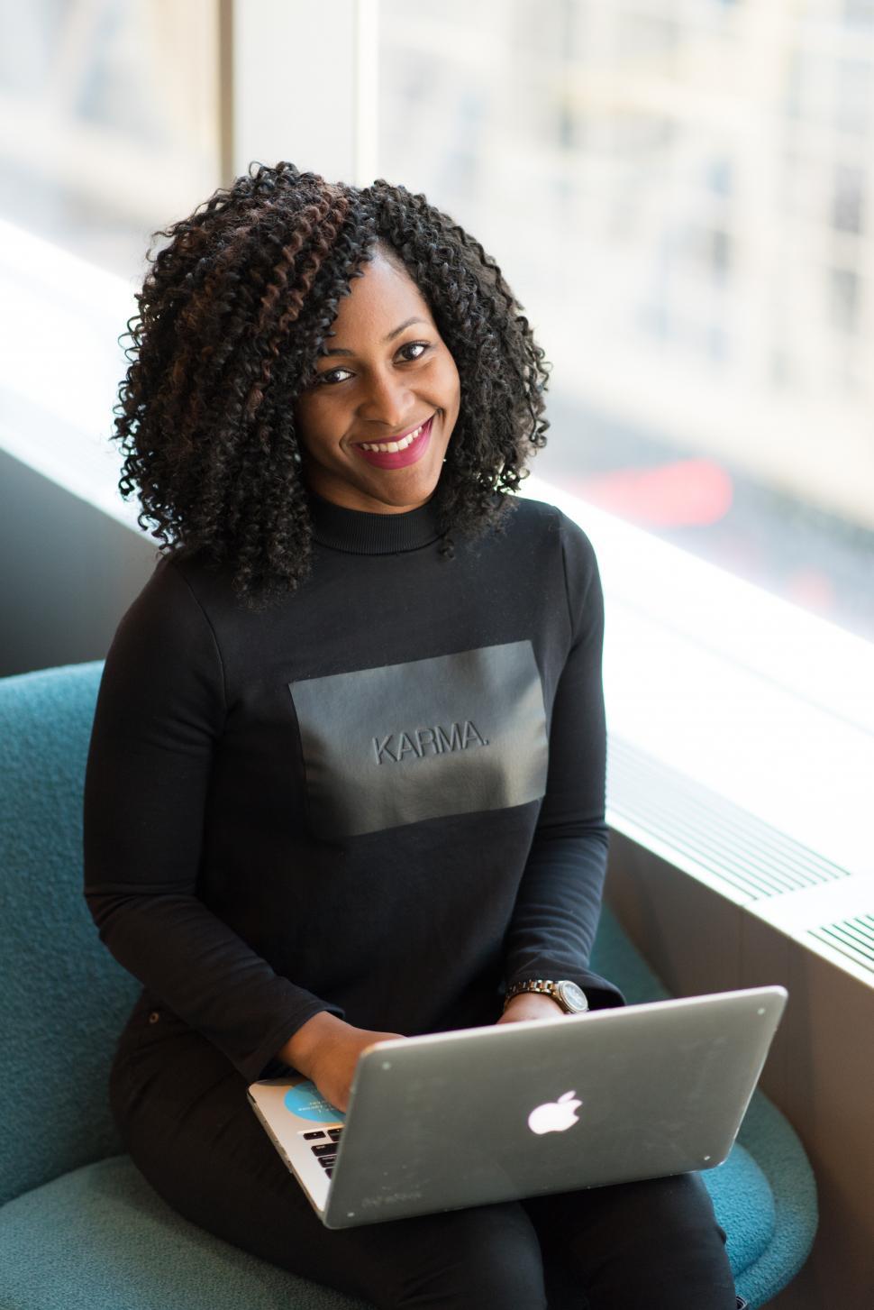 Free Image of Businesswoman in casual clothing working on laptop - looking at 