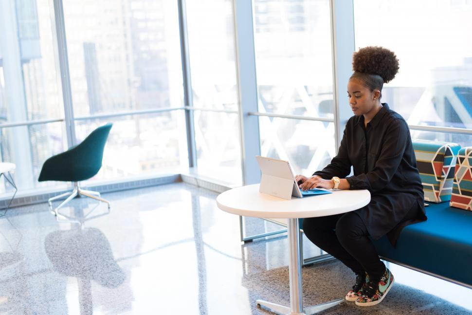 Free Image of Woman in black shirt working on a laptop 