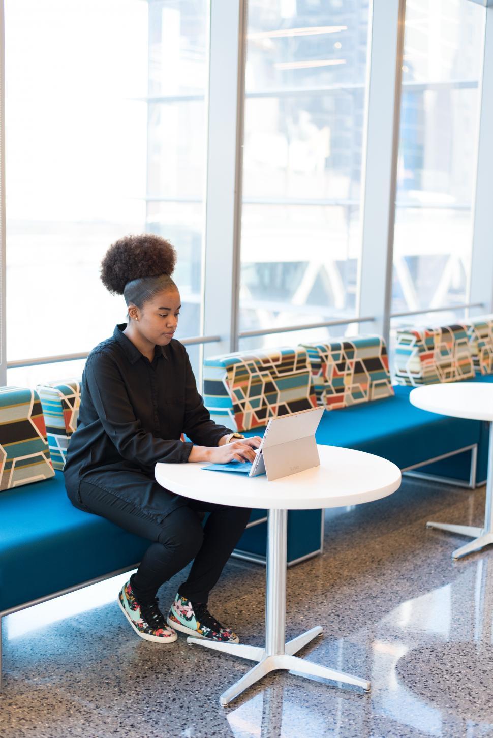 Free Image of Woman in black shirt working on a laptop 