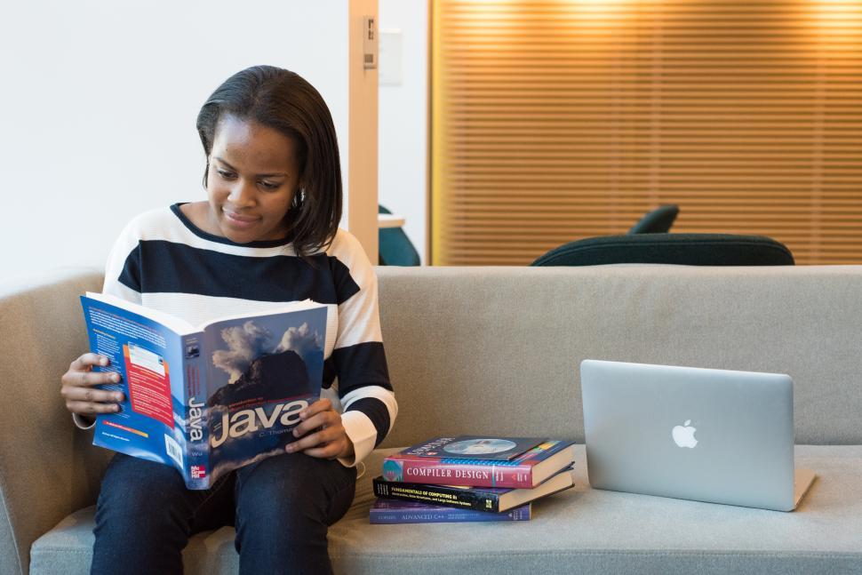 Free Image of Happy Female developer with book 