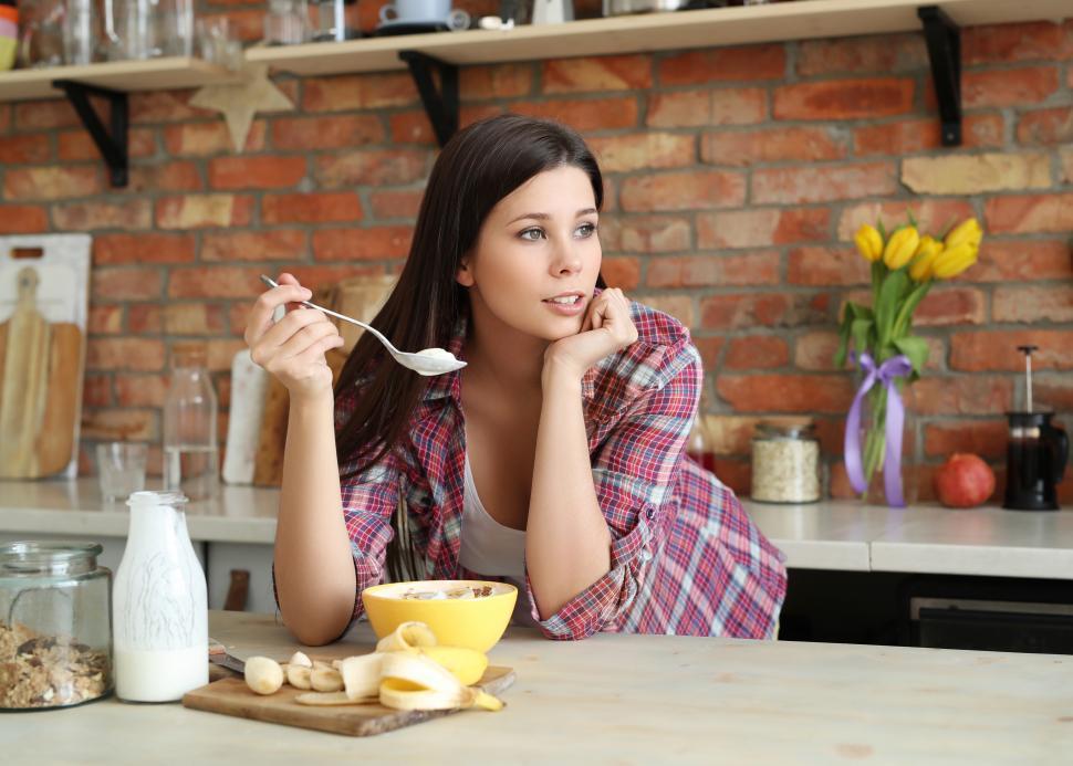 Free Image of Woman at the counter with a food 
