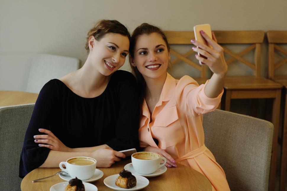 Free Image of Women in cafe taking a selfie 