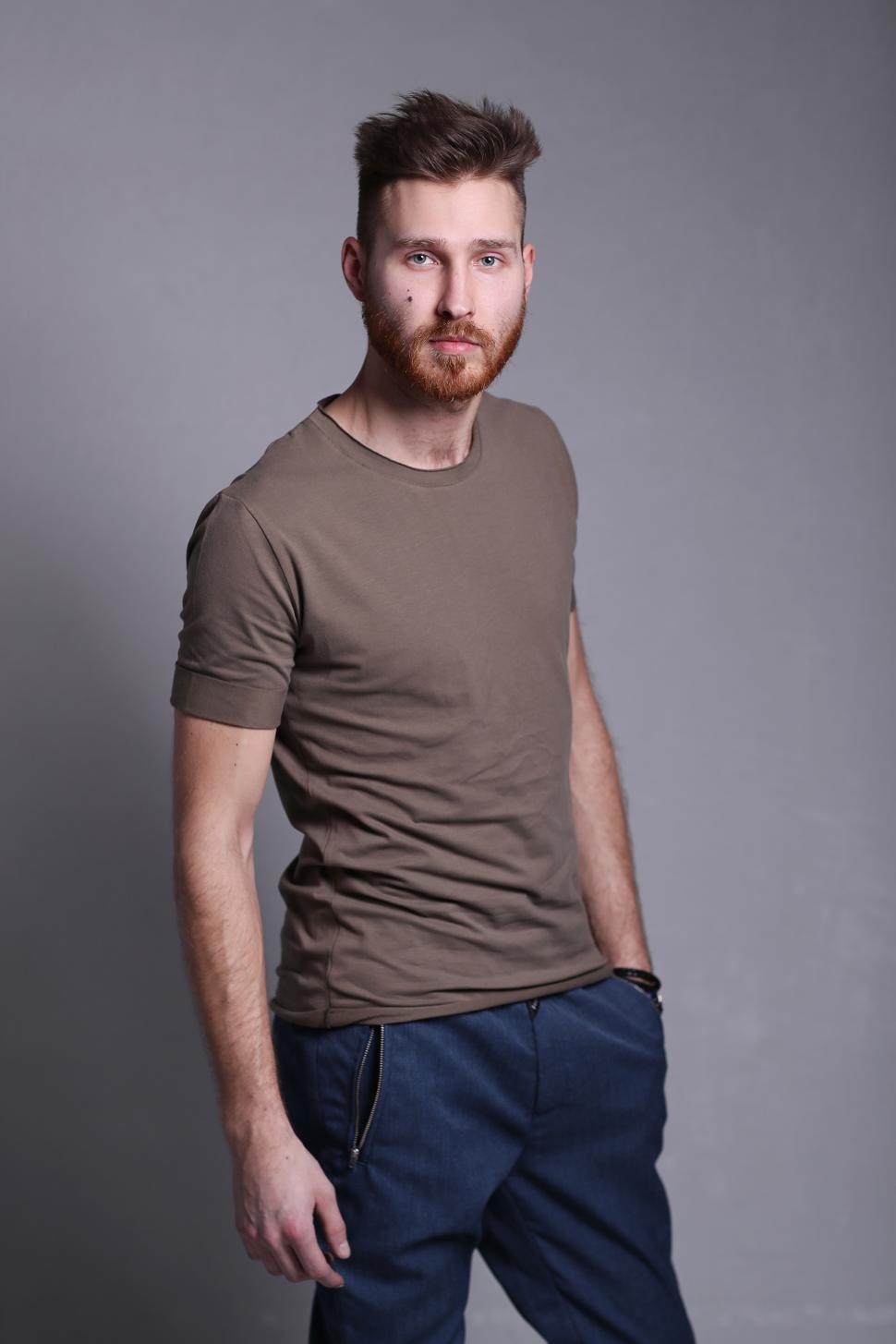 Free Image of Man in t-shirt posing and looking at camera 