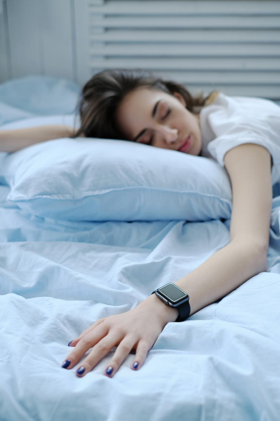 Free Image of Woman with smart watch on her wrist, in bed 