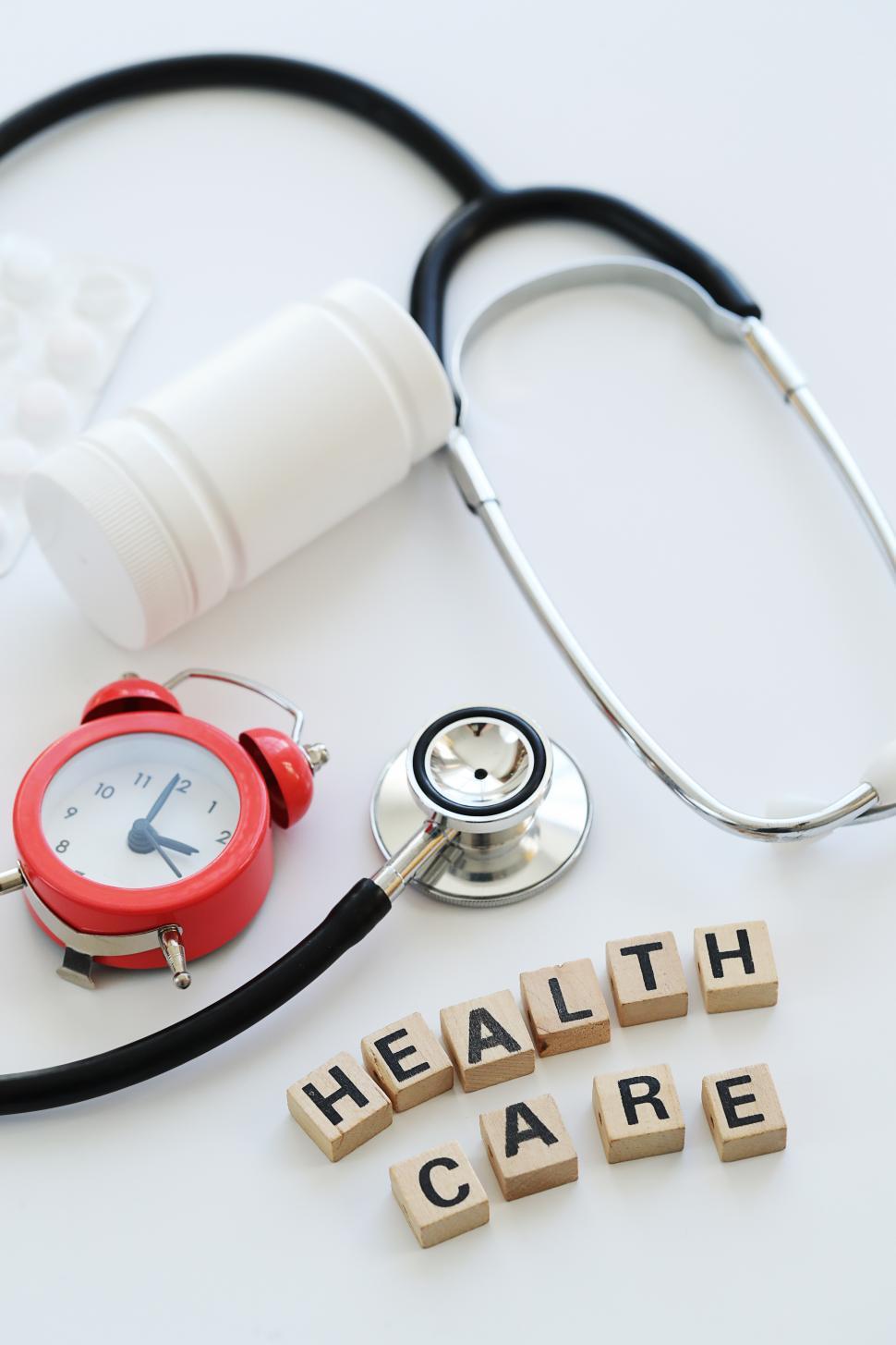 Free Image of Healthcare spelled out in tiles with medical equipment 