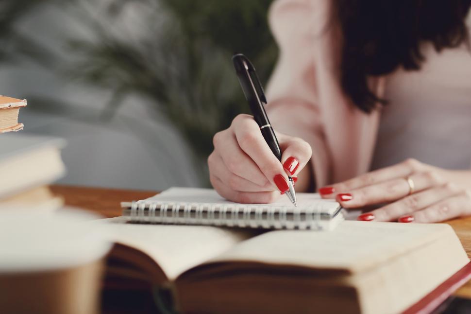 Free Image of Woman in the library writing 