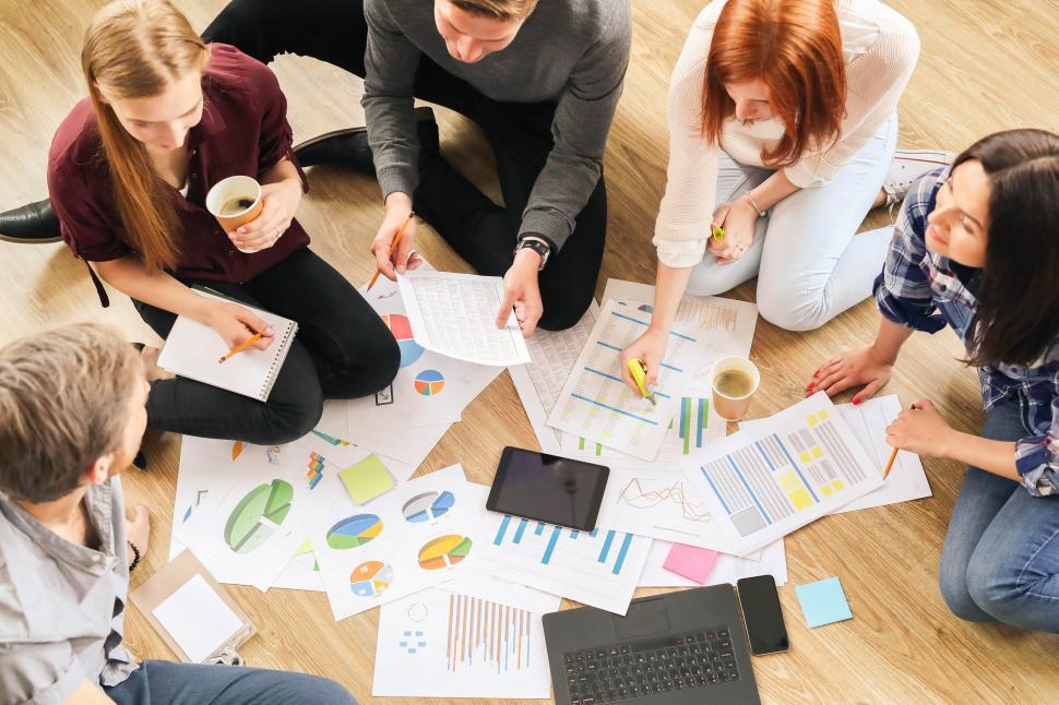 Free Image of People in the office sitting on the floor working together 