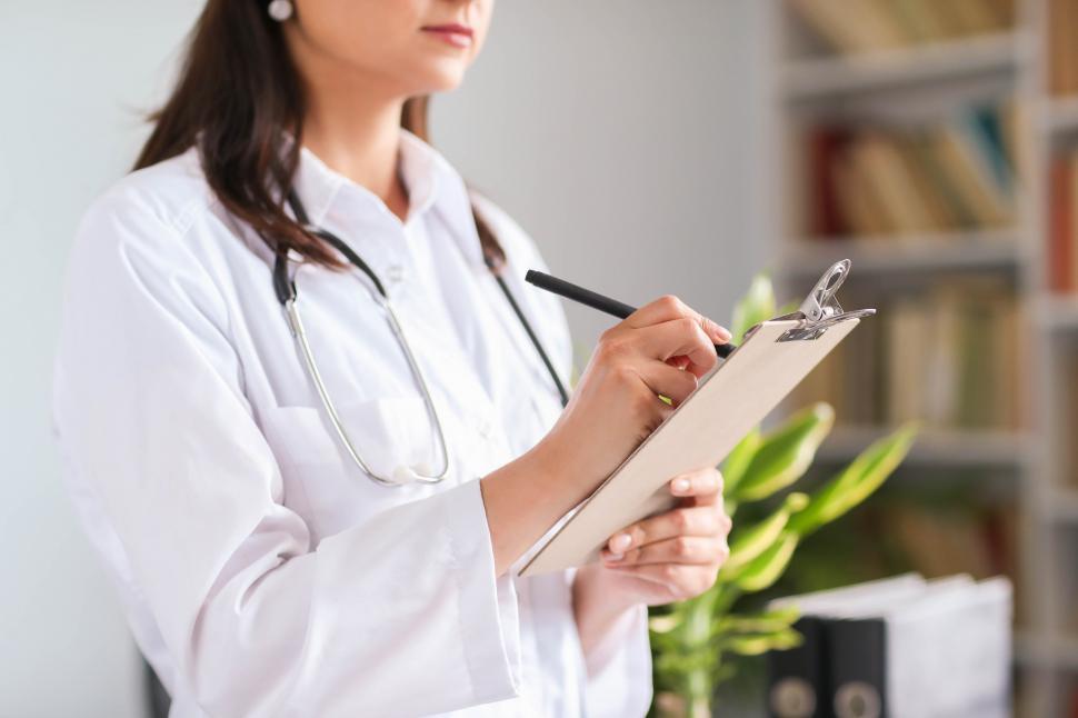 Free Image of Doctor writing notes 
