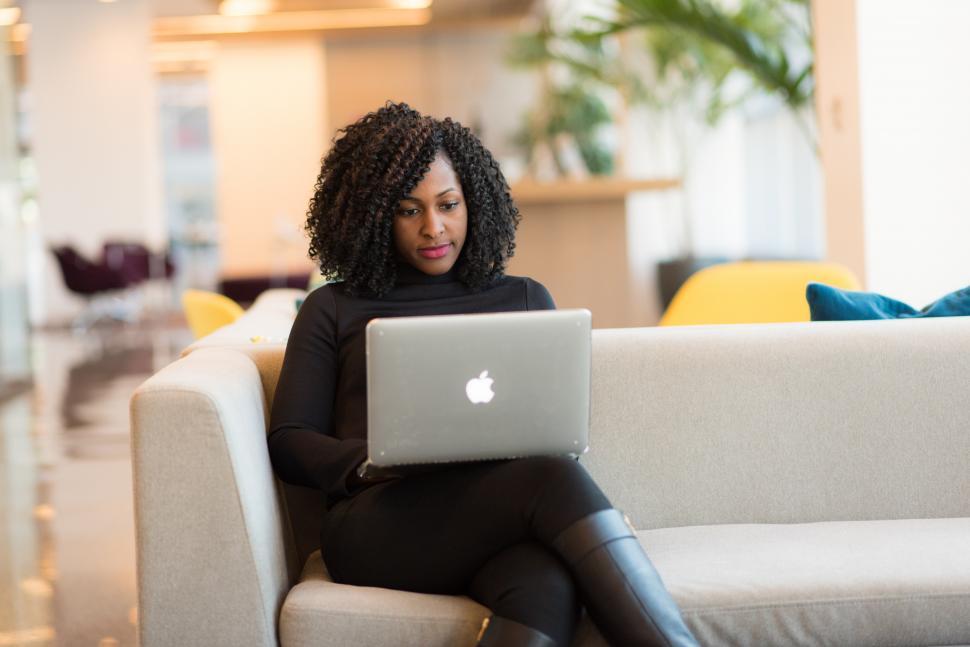 Free Image of Businesswoman with laptop sitting on couch 