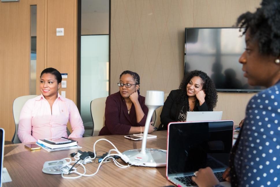 Free Image of Happy Businesswomen discussing a plan with laptop in meeting roo 