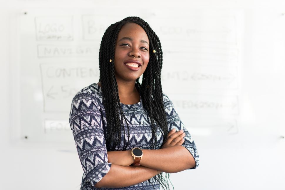 Free Image of Smiling female professional posing for camera in office 