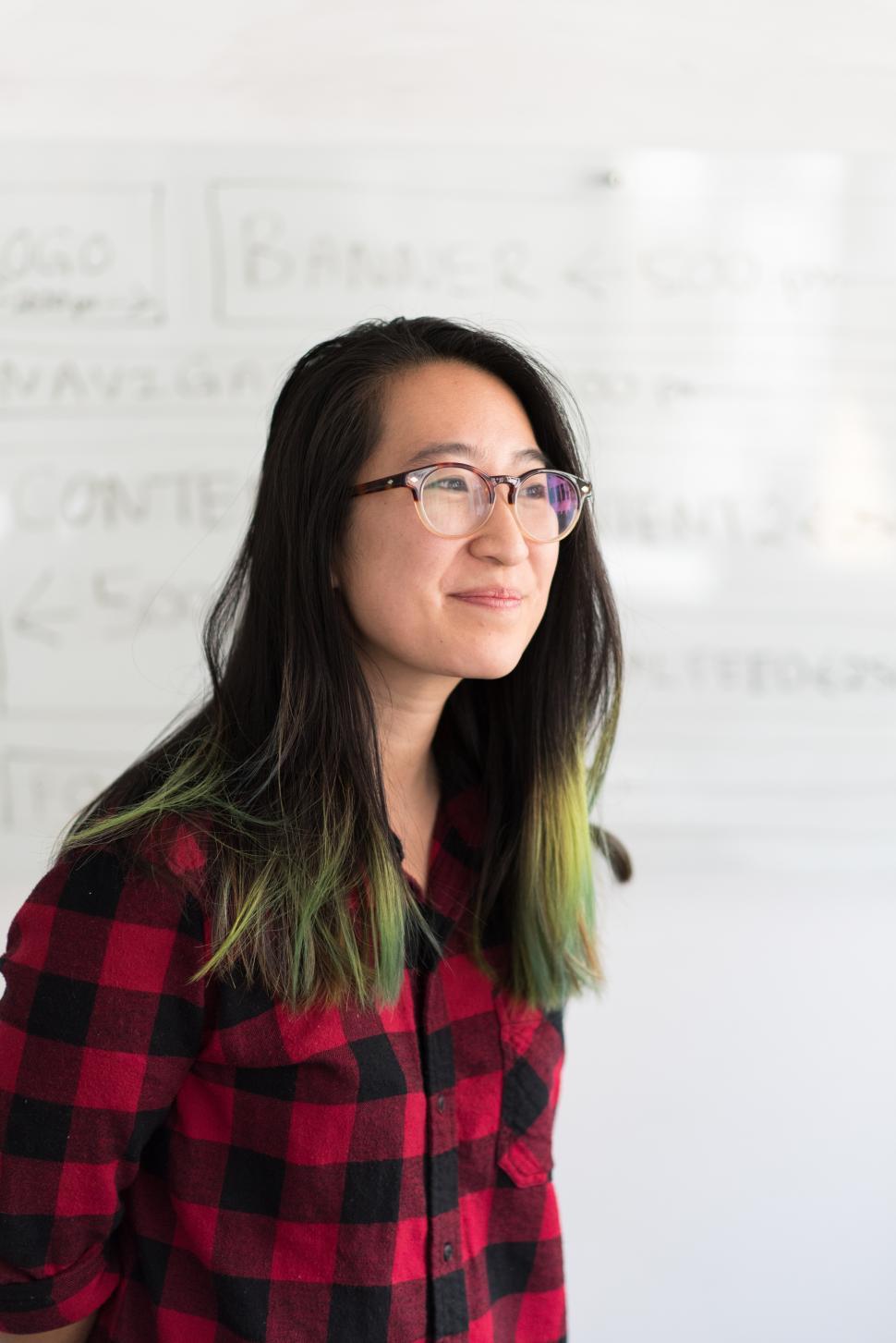 Free Image of Female professional smiling for camera in office 