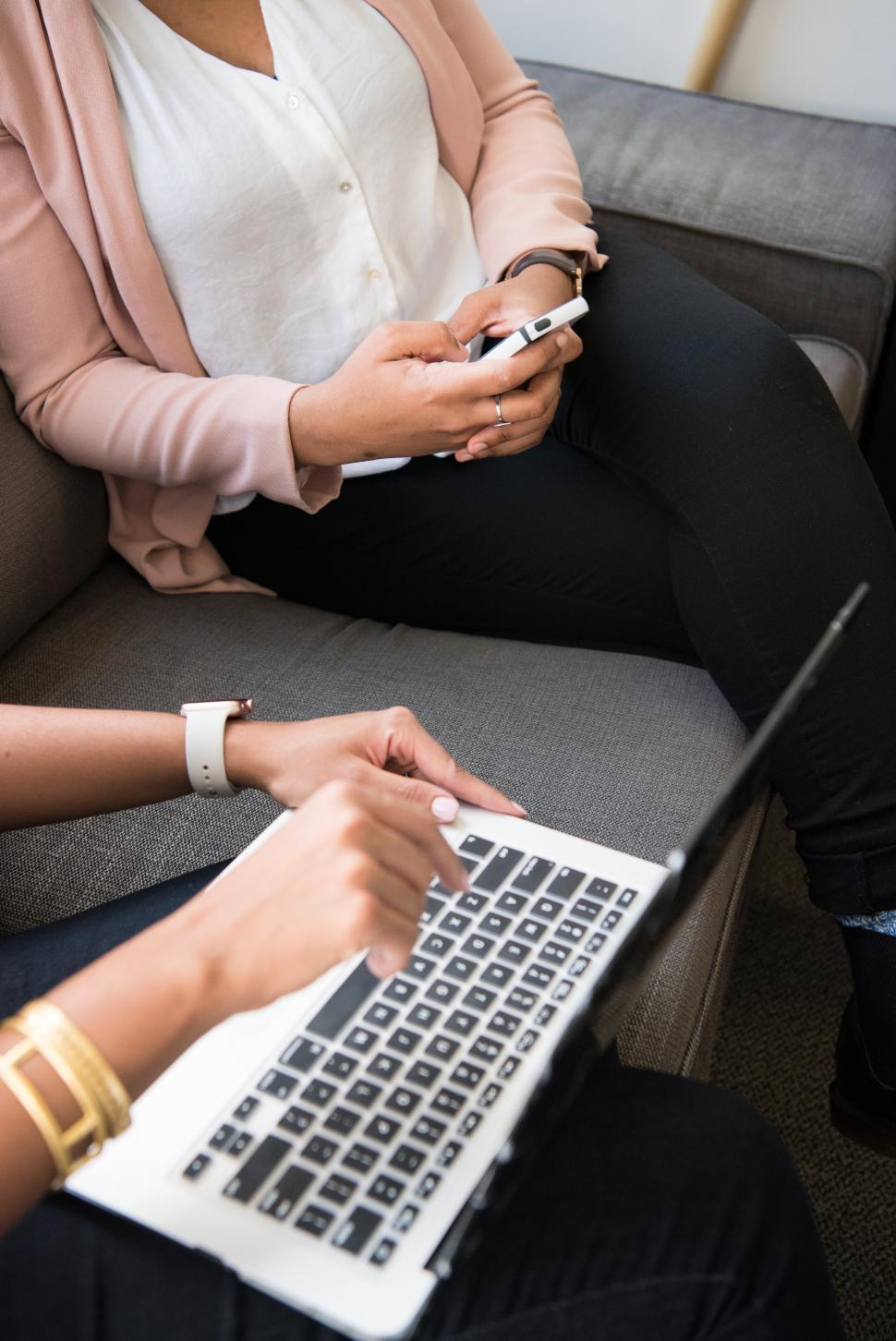 Free Image of Stylish female colleagues discussing with laptop 