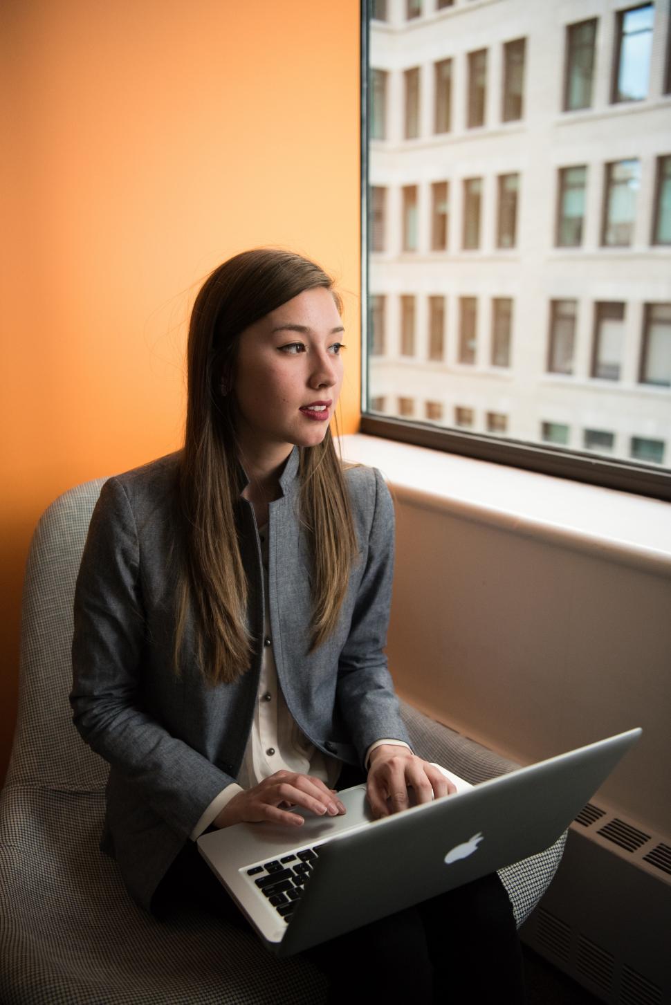 Free Image of Female using laptop near window in office 