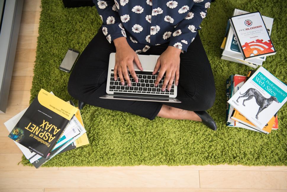 Free Image of Female developer with laptop and books 
