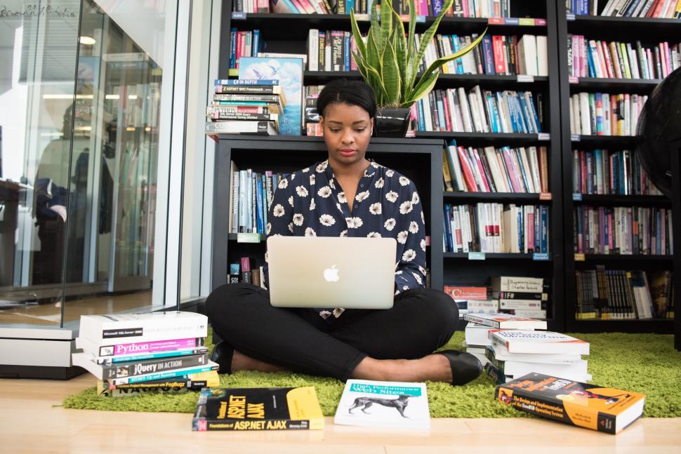 Free Image of Female developer with laptop in library 