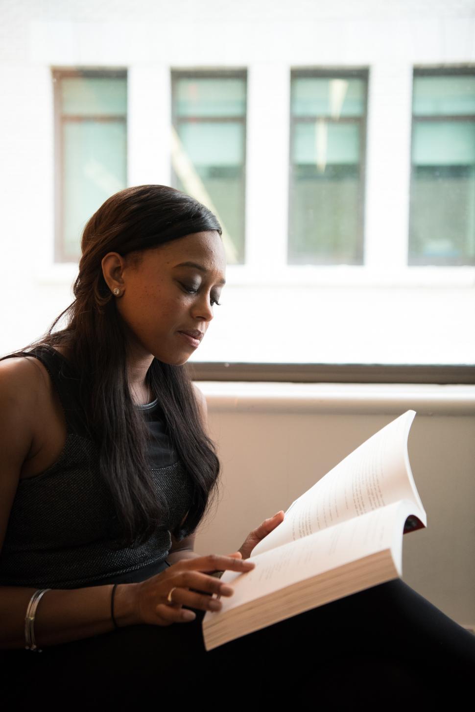 Free Image of Woman with book - looking down at book 