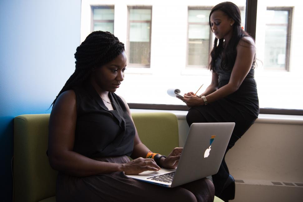 Free Image of Two business women with laptop and notepad 