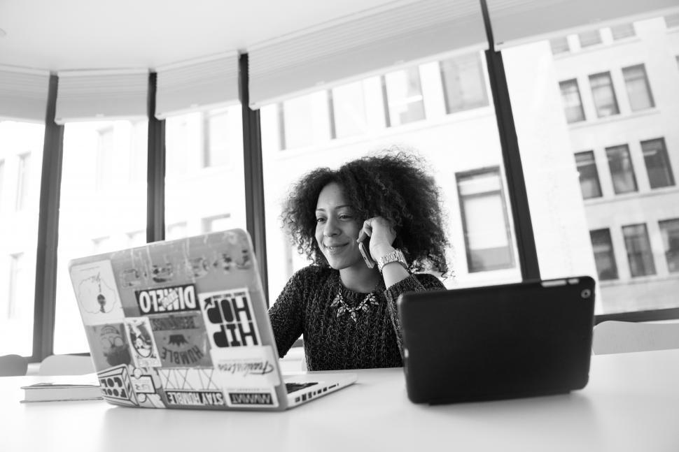 Free Image of Stylish young woman with laptop in office - looking at screen 